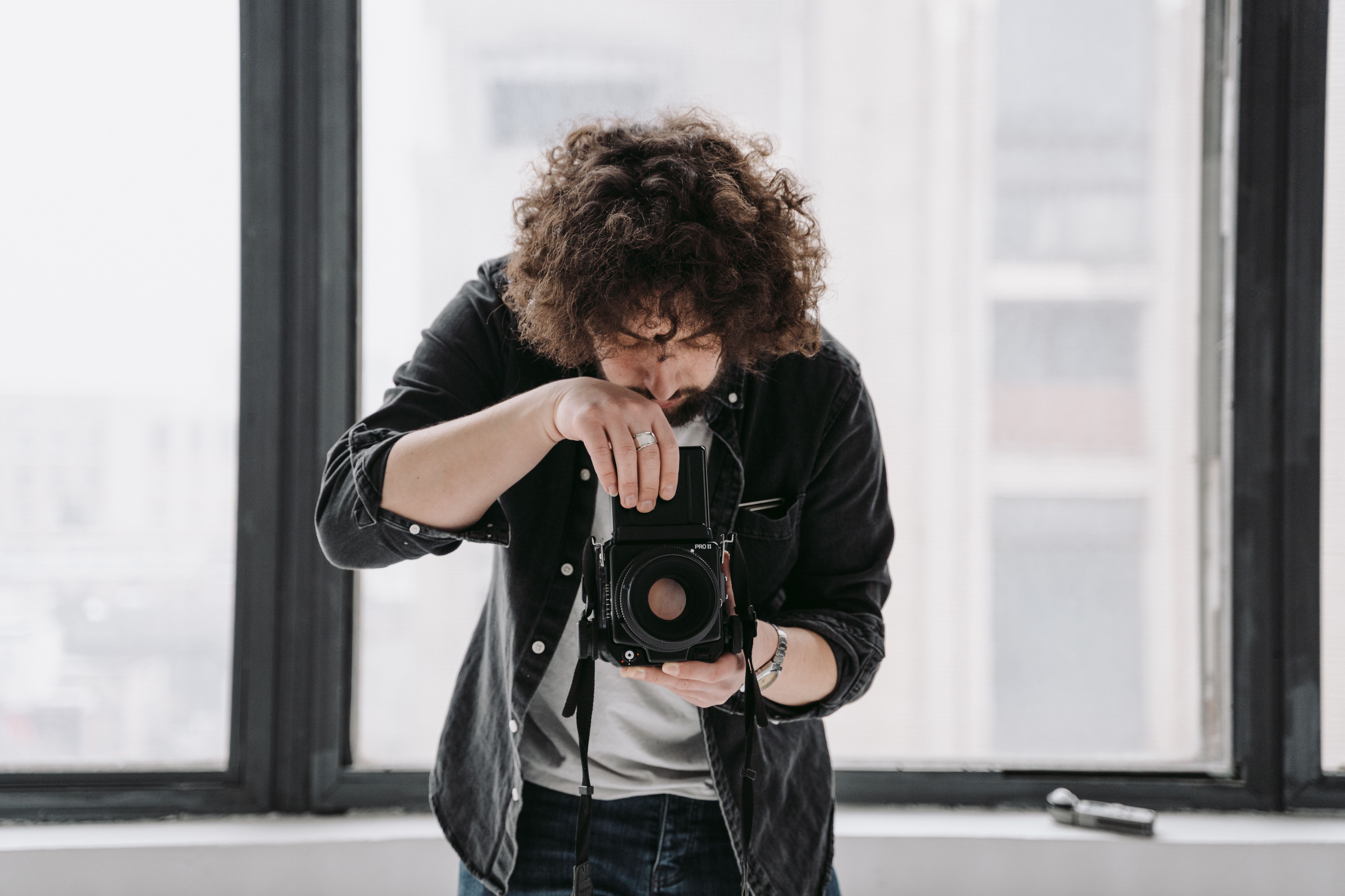 Portrait of the photographer holding a vintage camera